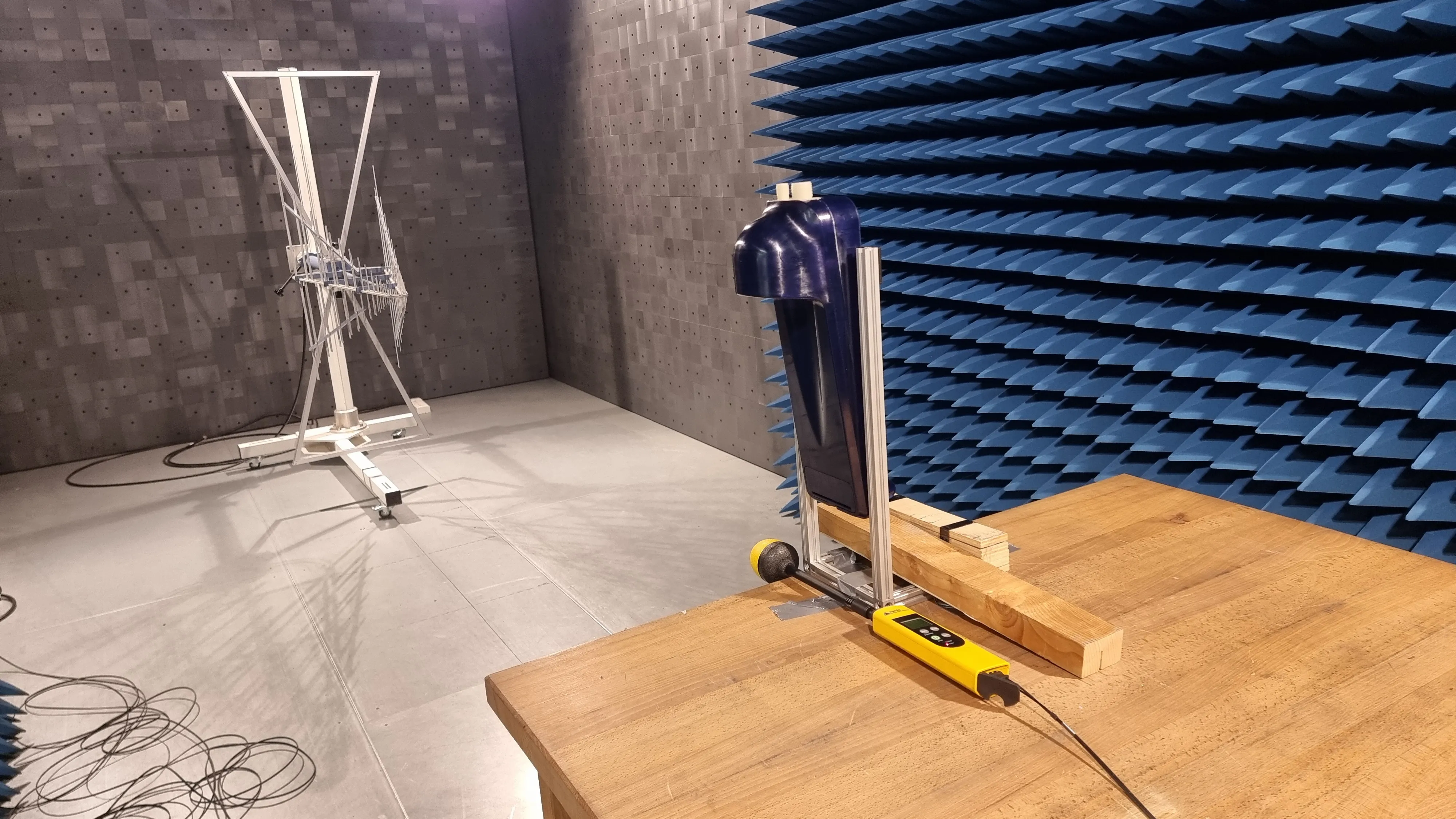 ROBI filter unit on a test fixture in an anechoic EMC chamber, with a measurement antenna in the background